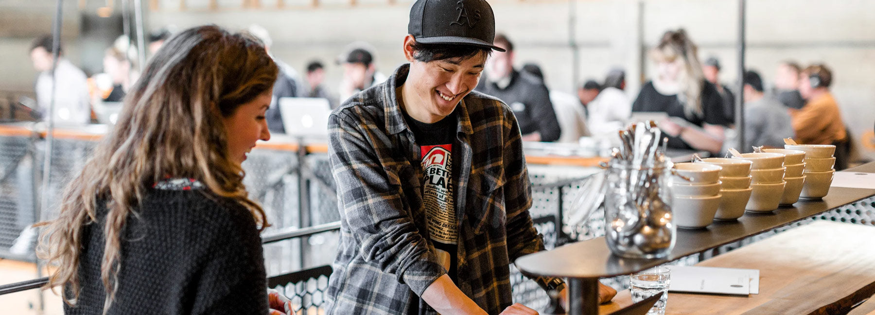 Person interacting with a barista during a Sightglass Coffee class