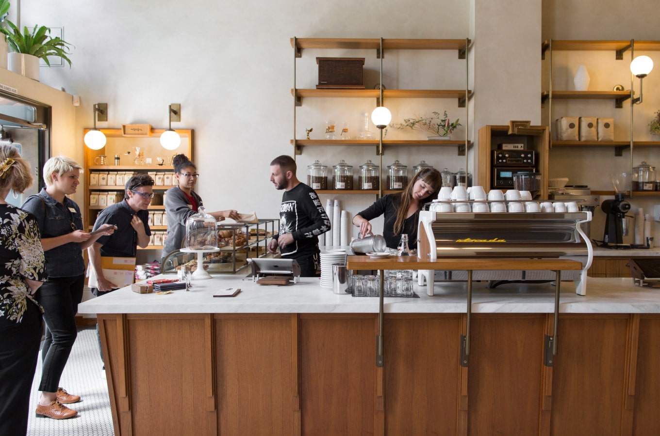 Interior view of Sightglass Coffee in the Mission San Francisco. Sleek design with wood panels and a sparkling new espresso machine.