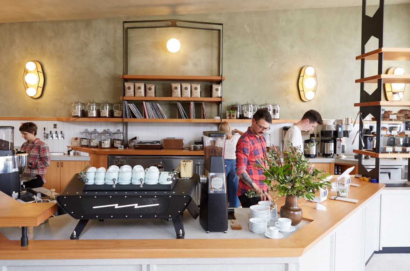 View of the counter with baristas working at Sightglass Coffee Divisadero location in San Francisco.