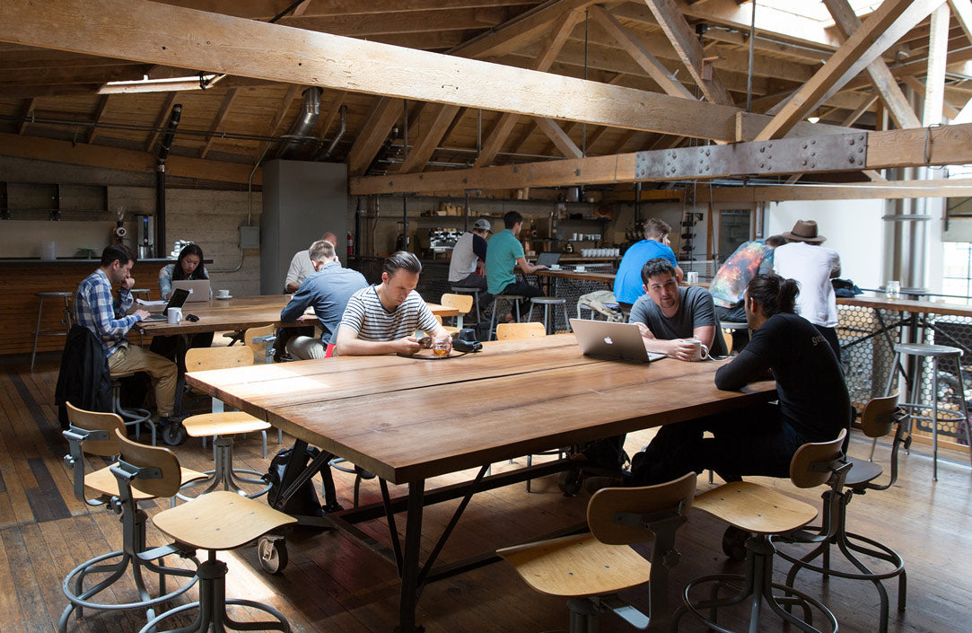 Upstairs view with guests chatting and drinking coffee at Sightglass Coffee's SoMa location.