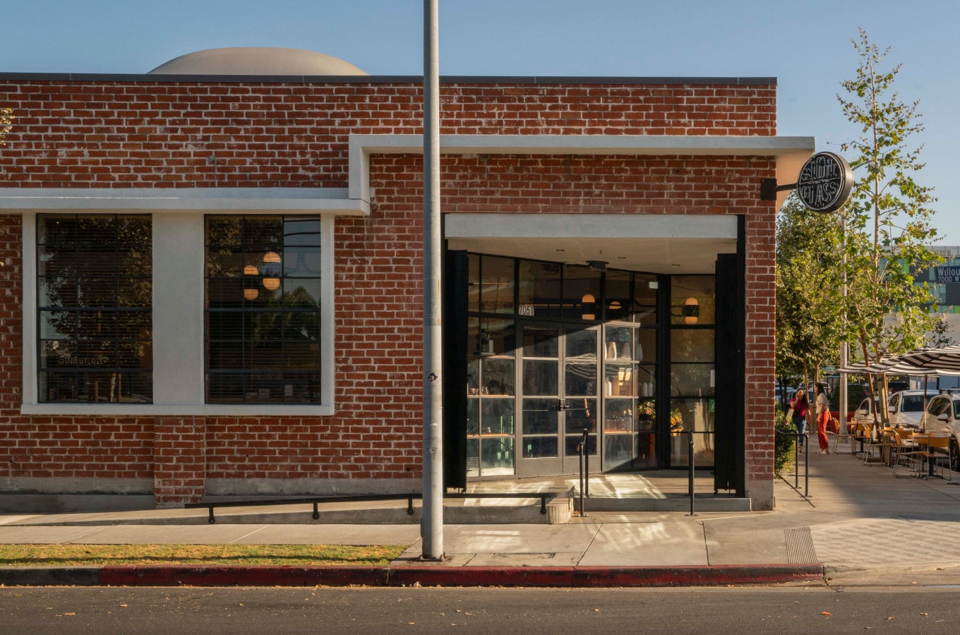 Sightglass Coffee window at the Hollywood location, at the corner of Sycamore and Willoughby avenues, during the day with the Neon Sign off.